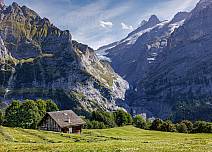 While the last of the hay for the winter dries in the summer sun in the foreground, the foothills of the Upper Grindelwald Glacier are already in the shade. (bei Klick vergrösserte Ansicht Bild)